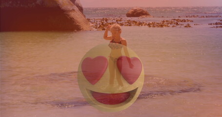 Gazing at horizon kid in shallow water by seaweed on rocky beach floral bikini heart-eyes emoji