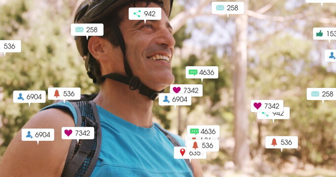Smiling cyclist wearing helmet standing on trail with backpack and notification icons, copy space