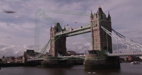 Showing historic Tower Bridge raising central span over River Thames, with small vessel below