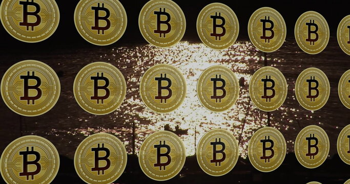 Fototapeta Shimmering golden Bitcoin coin icons floating over rippling water at sunset, cryptocurrency theme