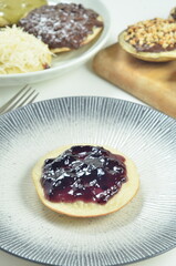 Serabi pancakes topped with blueberry jam, a traditional Indonesian snack