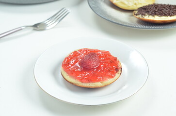 Serabi pancakes topped with strawberry jam, a traditional Indonesian snack