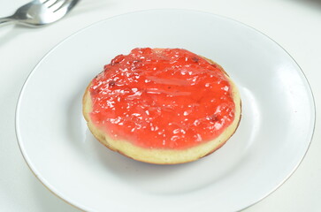 Serabi pancakes topped with strawberry jam, a traditional Indonesian snack
