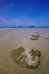 Beach Asia. Asian island beach with large stones, clear seas and blue skies