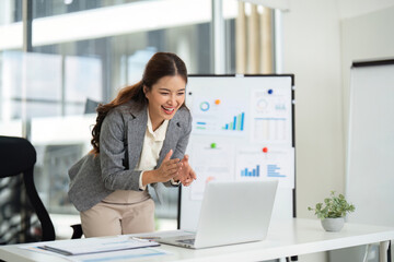 Fototapeta premium Professional Woman Celebrating Success in Modern Office