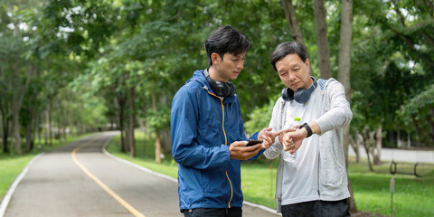 Health and Wellness. Two men enjoying outdoor fitness activity in a park.