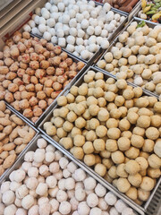 Top-angle shot of stew ingredients or sukiyaki dish. Stew ingredients consist of cheese dumplings, soup dumplings, fish balls, shrimp and crab balls, Chikuwa. Cooking ingredients in the supermarket.
