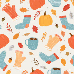 A cozy autumn seamless pattern with pumpkins, knitted socks, mittens, and mugs of hot chocolate.