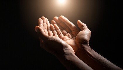Praying hands reaching upwards towards a bright, ethereal light, symbolizing hope and spirituality.