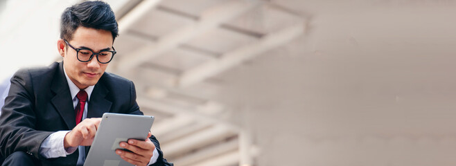 Banner Man hands typing laptop notebook holding coffee cup outside office. Panorama man hands using...
