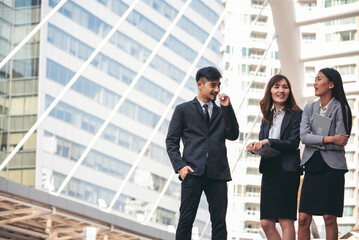 Group of Asian business people diversity talking meeting outside office. Multiethnic teamwork collaboration team meeting. Business people shaking hands together diversity multiethnic Business partner