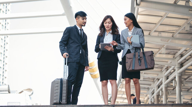 Group of Asian business people diversity talking meeting outside office. Multiethnic teamwork collaboration team meeting. Business people shaking hands together diversity multiethnic Business partner - Powered by Adobe