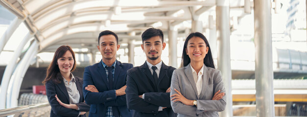 Group of business people asian team partners walking in city happy together. Leader executive men standing at modern urban city with confident teamwork. Portrait diversity businesspeople teamwork