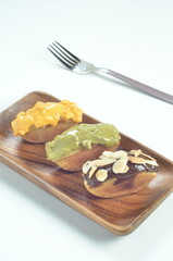 Pukis cake with various toppings of chocolate, cheese, peanuts, and matcha, a traditional Indonesian snack
