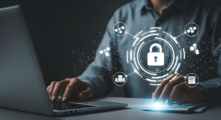 Person types on laptop at desk with lock icon over the screen, data security background
