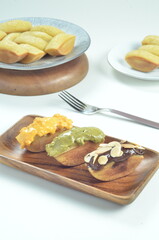 Pukis cake with various toppings of chocolate, cheese, peanuts, and matcha, a traditional Indonesian snack