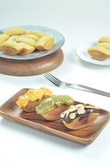 Pukis cake with various toppings of chocolate, cheese, peanuts, and matcha, a traditional Indonesian snack