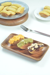 Pukis cake with various toppings of chocolate, cheese, peanuts, and matcha, a traditional Indonesian snack