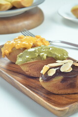 Pukis cake with various toppings of chocolate, cheese, peanuts, and matcha, a traditional Indonesian snack