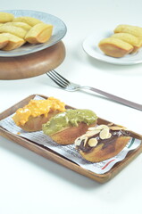Pukis cake with various toppings of chocolate, cheese, peanuts, and matcha, a traditional Indonesian snack