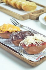Pukis cake with various toppings of chocolate, cheese, peanuts, and matcha, a traditional Indonesian snack