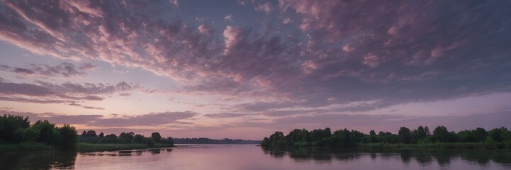 Fototapeta premium Serene River Landscape with Pink and Purple Sunset Sky and Cloudy Atmosphere