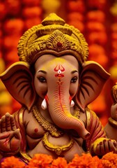 Close up of lord ganesha idol with orange flower background, a symbol of wisdom and prosperity