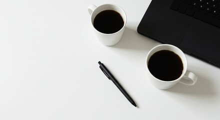 Stock photo of laptop with coffee cups and pen on desk for work from home concept and office supplies