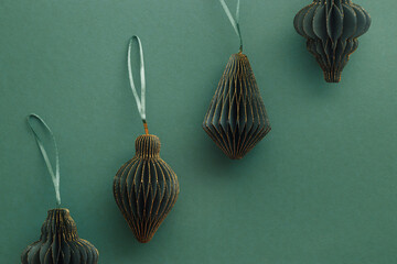 Green Christmas paper toys as flashlights on paper texture background, Scandinavian Christmas...