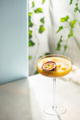Mango passion fruit cocktail in a glass on the table