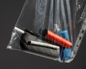 Electronic cigarettes and disposable vapes in a bag. 