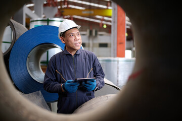 Technician or worker working on tablet and checking Sheet metal products in the factory