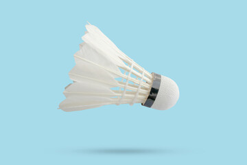 Badminton shuttlecock floating on blue background