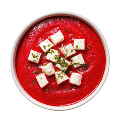 Red soup, topped with white cheese cubes and herbs