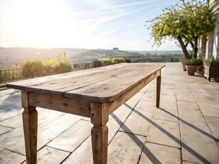 Rustic wooden table on a sunny patio overlooking rolling hills