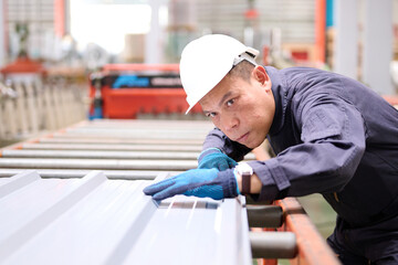 Technician or worker checking metal sheet in the factory