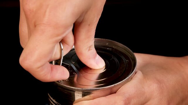 Hand Opening Can of Canned Green Beans Close-Up