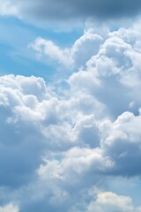 Obraz premium Vast clear blue sky with soft white clouds drifting gently across the horizon, capturing the light and airy atmosphere of a peaceful sky scene viewed from above with a sense of openness and serenity