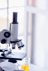 Vertical Horizon Science laboratory chemistry test science lab with microscope glass tubes on white table scientific background. Vertical Colorful Liquid biology scientist laboratory chemical fluid