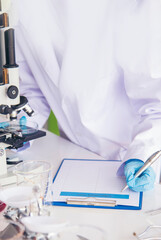 Vertical Horizon Woman scientist lab looks at science microscope medical test research biology chemistry. Vertical Females Technician Laboratory pharmacy research. Scientist Chemistry Medical test lab