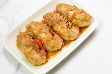 Delicious golden fried shrimp served on a white plate, perfect for seafood lovers and culinary enthusiasts.