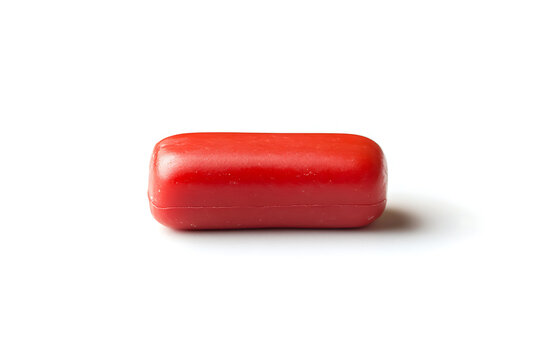 Single red pill on a white background