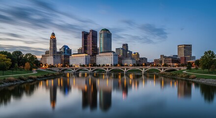 Fototapeta premium Cityscape reflection on scioto river with bridge and buildings at dusk in columbus ohio skyline view