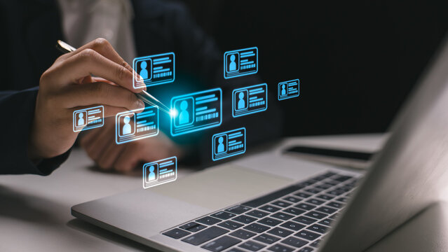 Businessman selecting digital profile on virtual screen using laptop, representing identity verification, user data management, and digital transformation in business and HR technology.