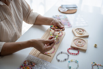 Senior mature older asian woman Art hobby handmade making beads jewellery accessories handcraft...