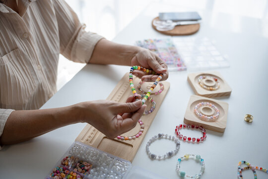 Senior mature older asian woman Art hobby handmade making beads jewellery accessories handcraft hobby