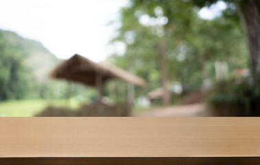 Empty wood table top and blur of restaurant background selective focus product display