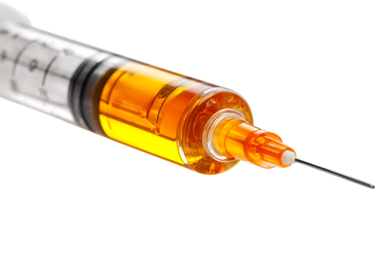 Close-up of a syringe filled with amber liquid.