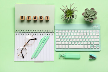 Cubes with text START, notebook and eyeglasses on green background. Top view
