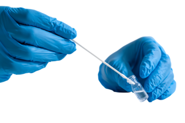 Gloved hands collect a sample.